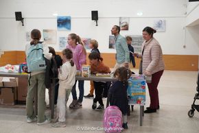 Stand de la collecte de dons tenu par le Conseil Municipal des Enfants en salle des fêtes de l'Hôtel de Ville.